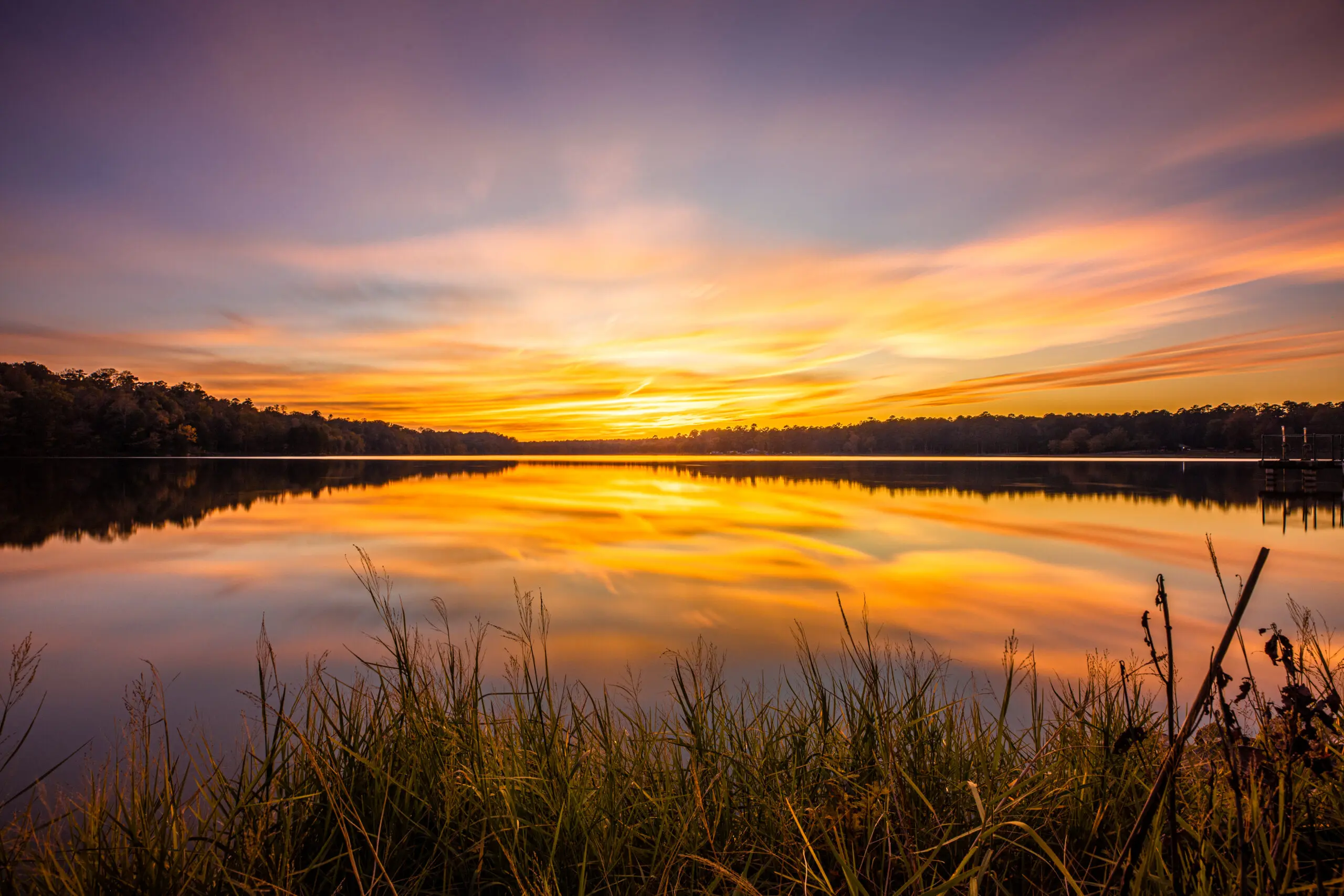 Colorful Sunset At Davis Lake A Sunset At Davis Lake.
At the mile post 243 exit on the Natchez Trace and about 4 miles you'll meet this 200 acre lake in Houston Mississippi.
Lots of fishing and camping here and a great setting for dramatic sunsets.